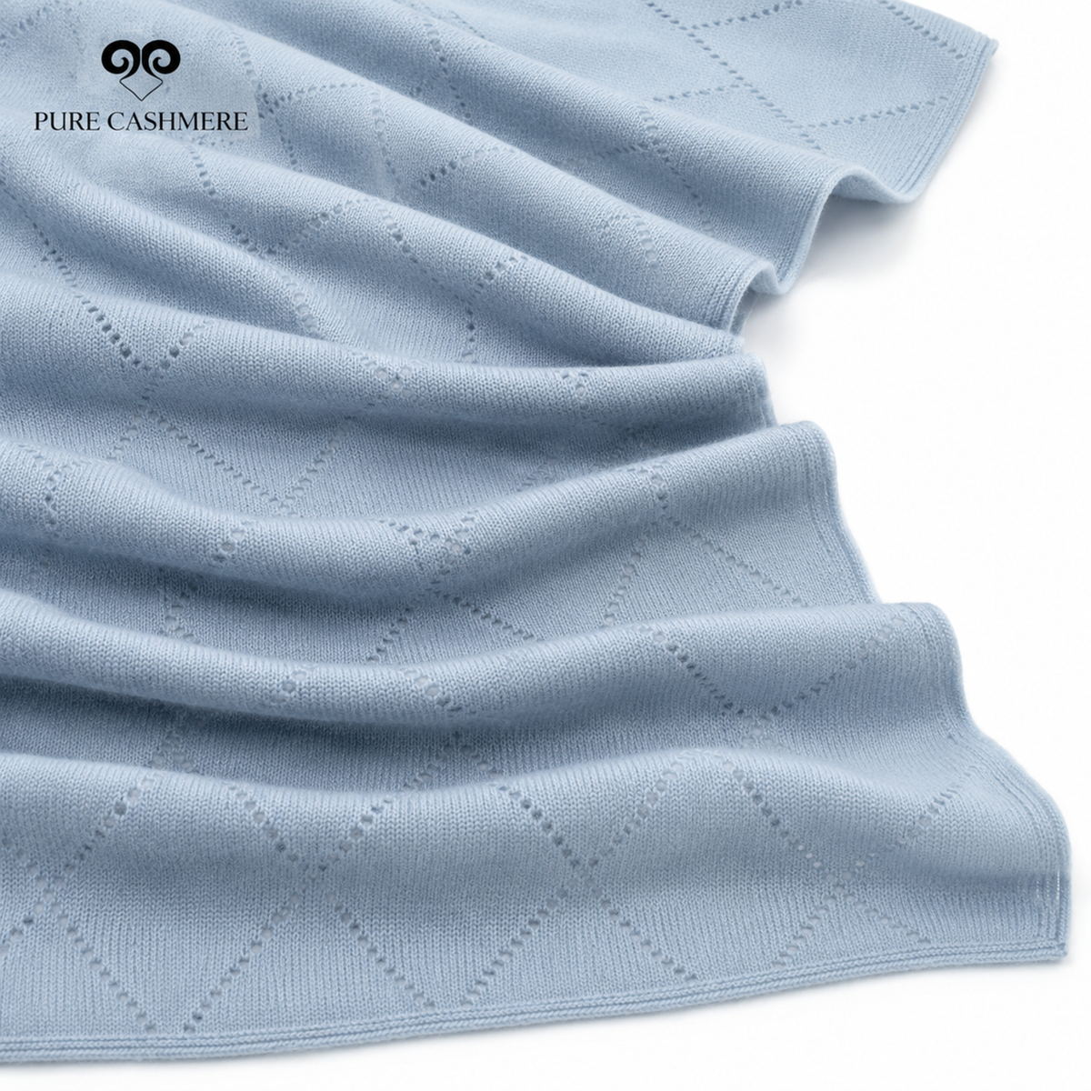 Close-up of powder blue cashmere knit fabric showing the weave and drape