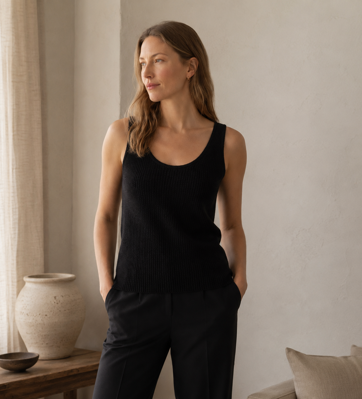 Grey sleeveless cashmere vest styled with tailored trousers