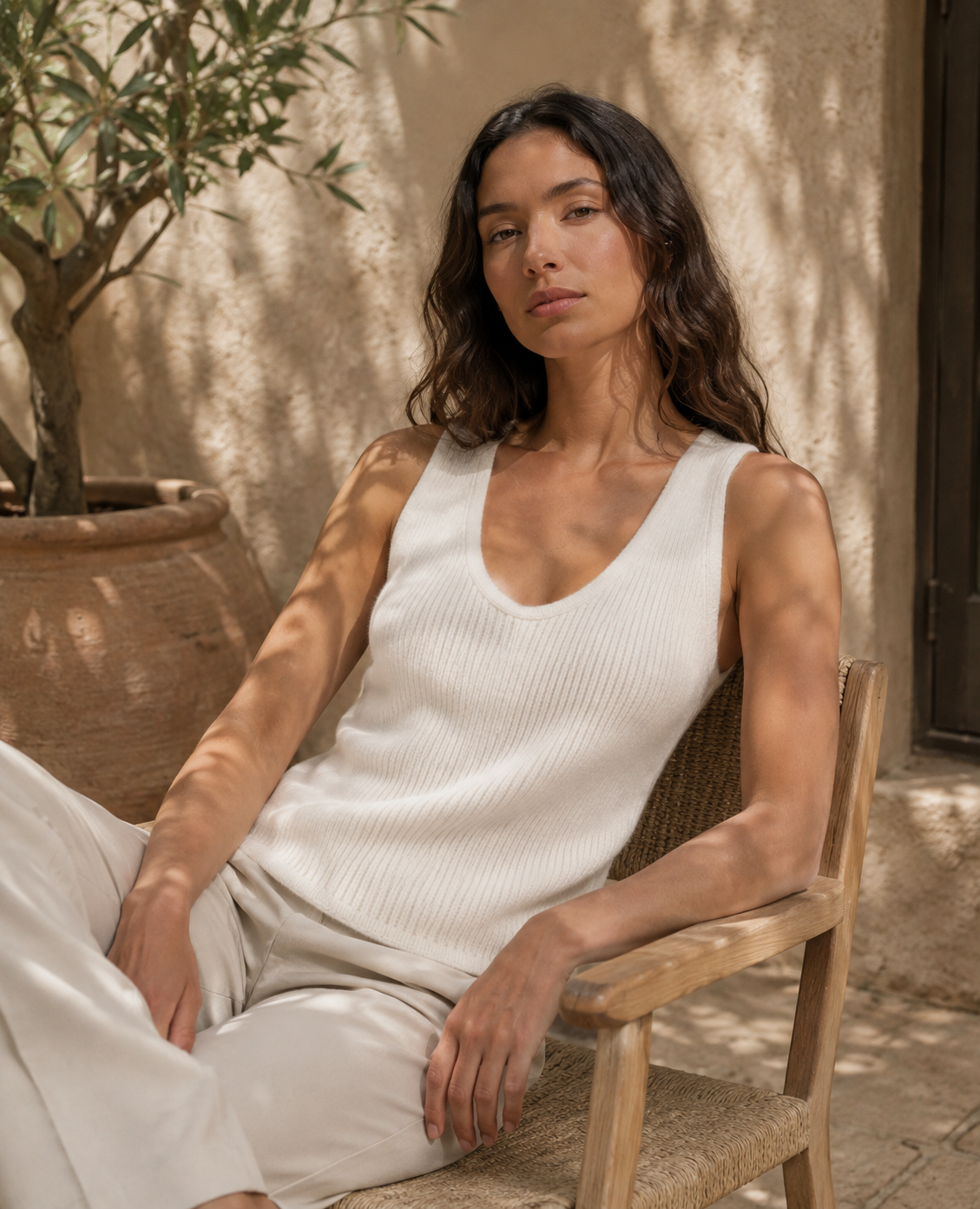 Grey ribbed cashmere vest shown from the side on model