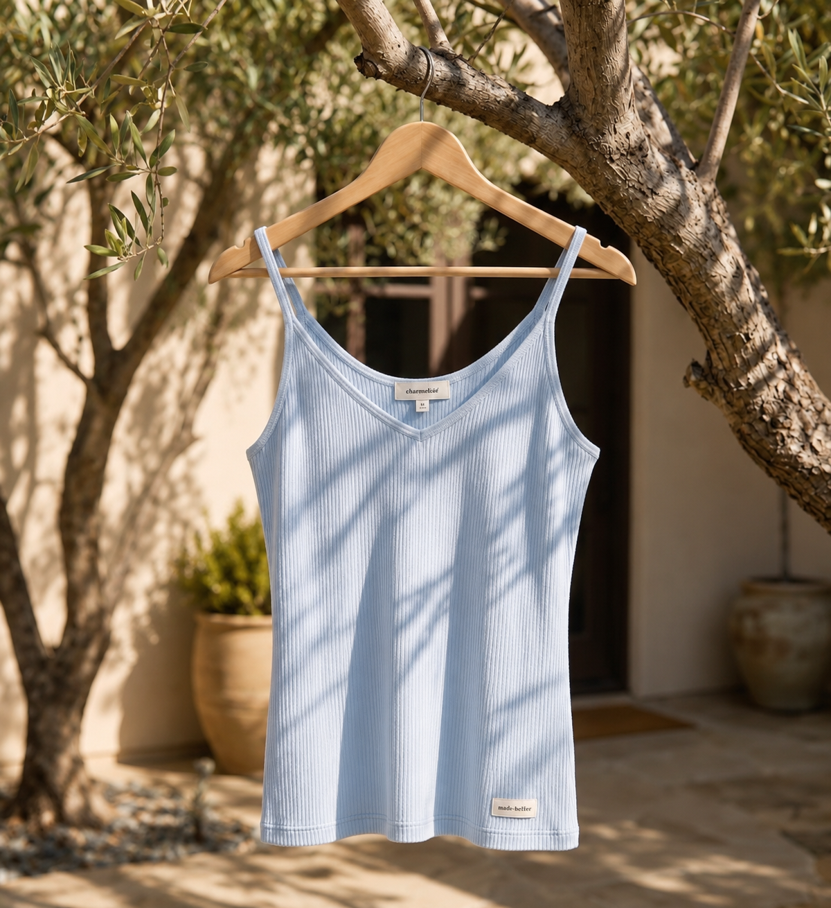 Light blue cashmere camisole shown on model as a layering top