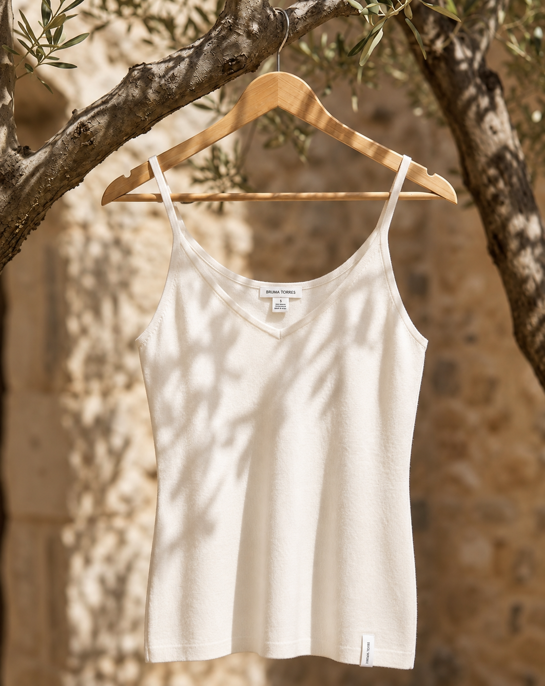 Close-up of the rib texture on a white cashmere camisole