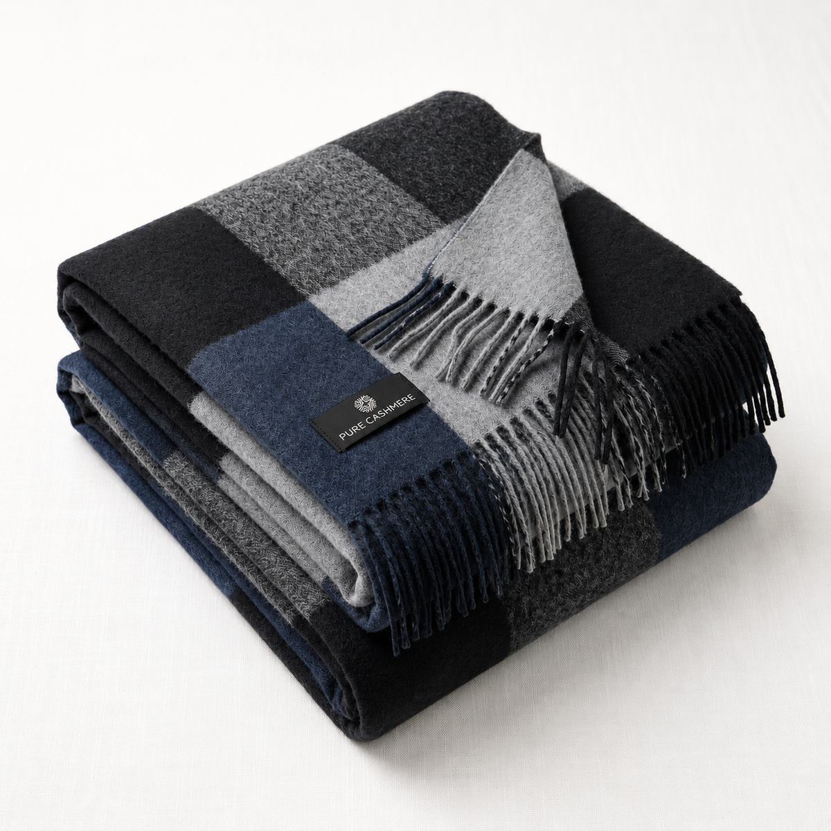 Close-up of the navy and grey check weave on a cashmere blanket scarf