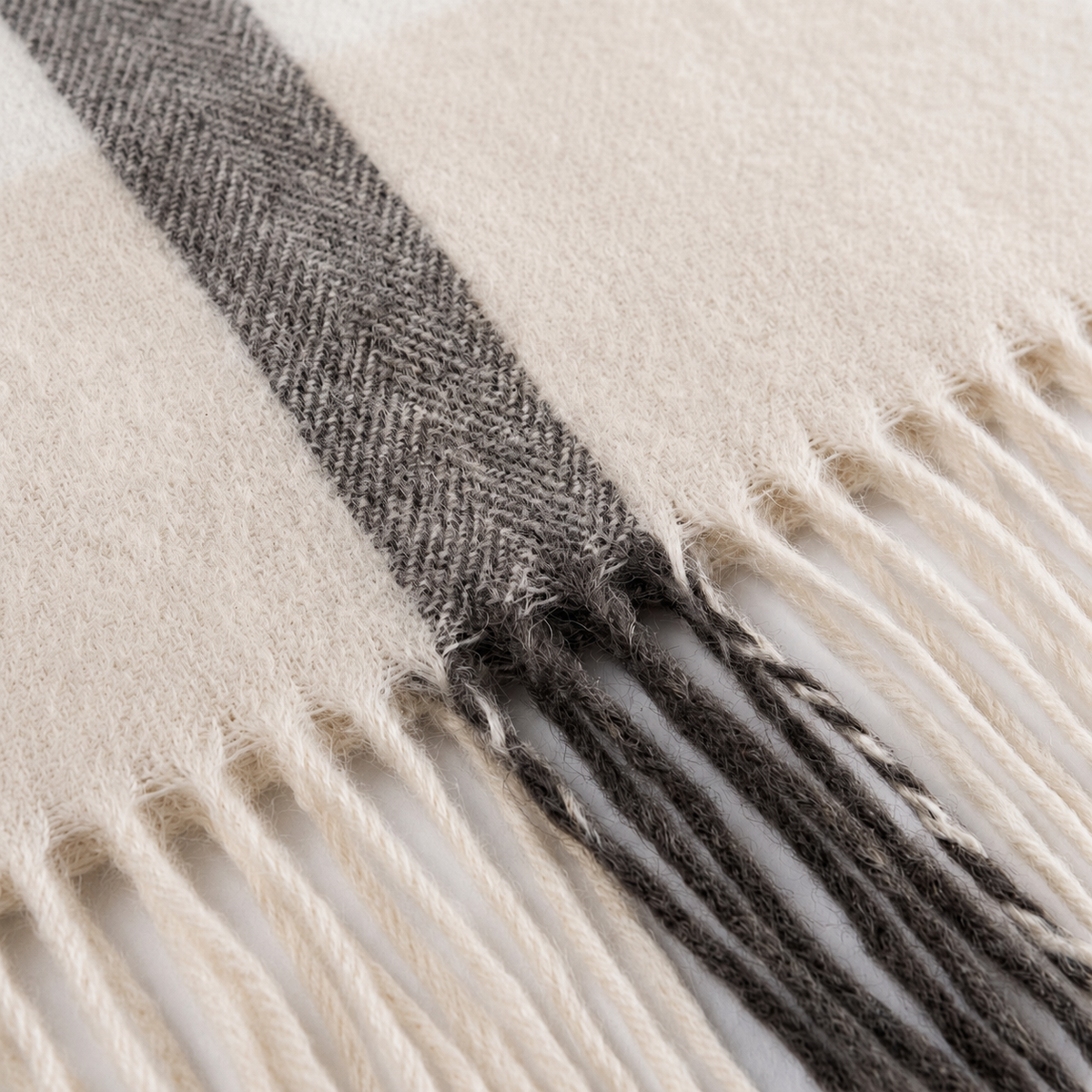 Cream cashmere wrap draped over the shoulder showing the drape